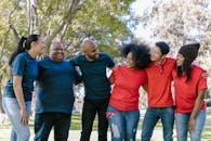 Six friends enjoy bonding outdoors, showcasing diversity and happiness.